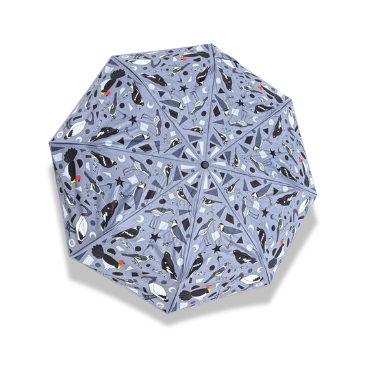 Grey umbrella with a black and white bird pattern featuring species found in Brisbane