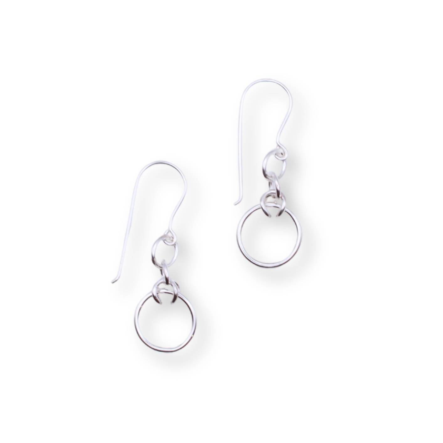 Pair of silver earrings on a white background