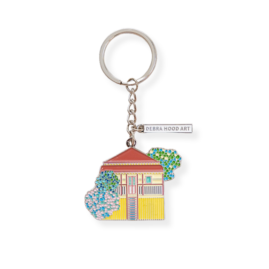 Keychain with a colorful house design and 'Debra Hood Art' tag on a white background