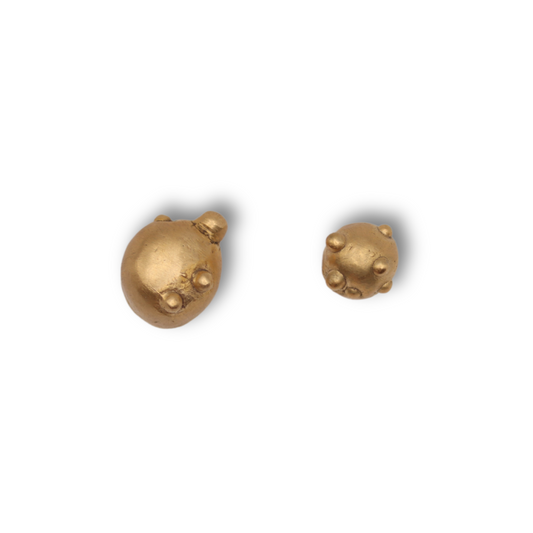 Gold stud earrings on a white background